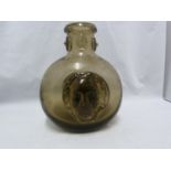 Seguso - a dark amber glass flask, the flattened globular body applied with a female head to each