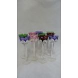 Moser - ten harlequin coloured liqueur glasses, the shallow circular bowls cases in various