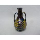 Venetian Glass - a miniature Phoenician two handled urn vase, the blue back glass with nacreous