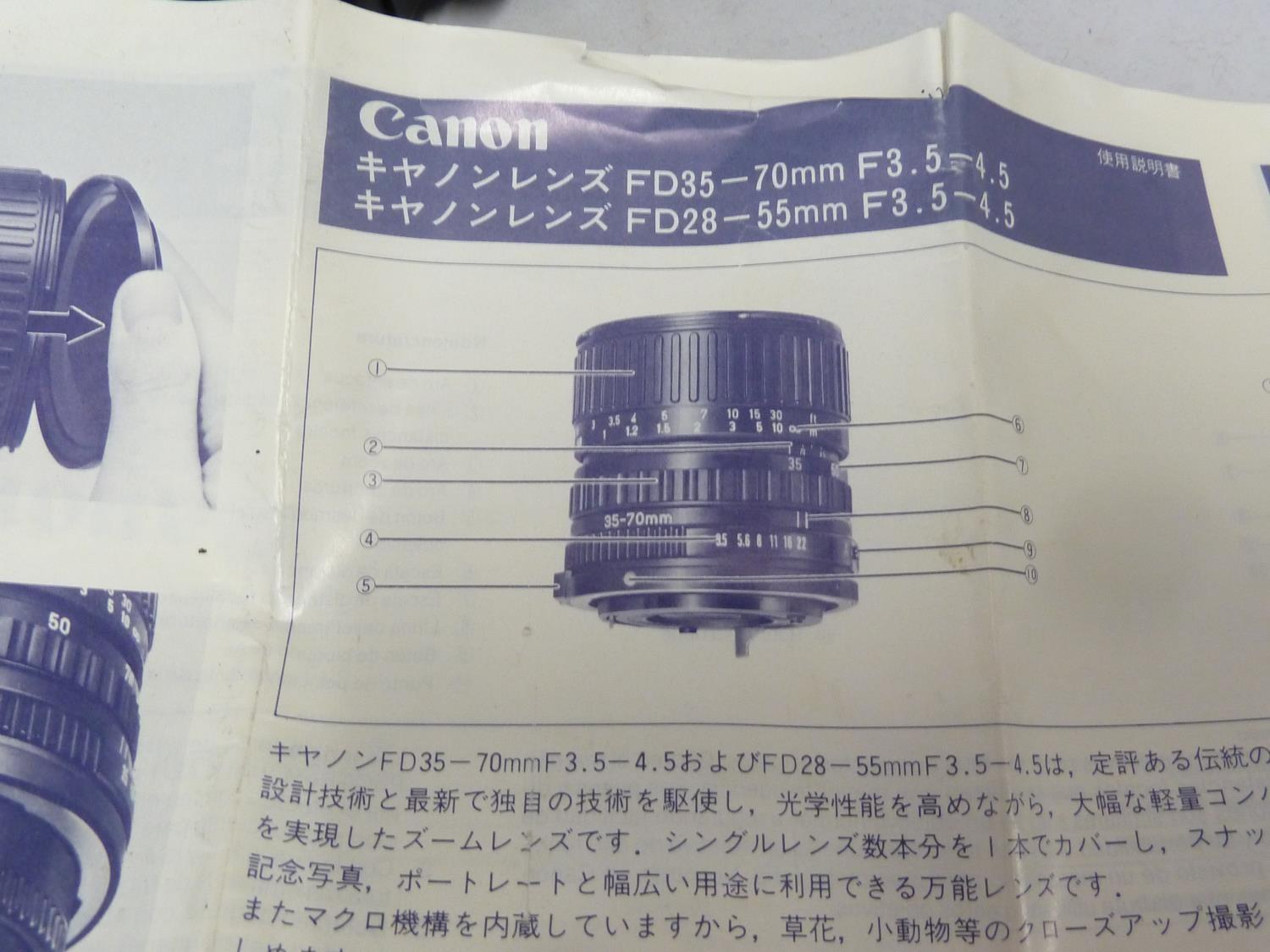 A Canon t70 camera body; a cannon Zoom Lens FD 35-70mm 1:3.6-4.5 with papers; and a Canon Speedlite - Image 2 of 5