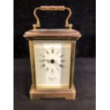 A small size brass carriage clock, four glass, the dial marked Bernand Freres Bicester, with key,