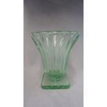 Daum - a translucent Art Deco sea green urn vase, of ribbed trumpet form on a canted square base,