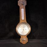 An oak cased barometer, with thermometer panel to neck, 53.5cm