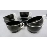 Bimini for the Wiener Werkstatte - a set of six deep amethyst black glass cups and saucers the