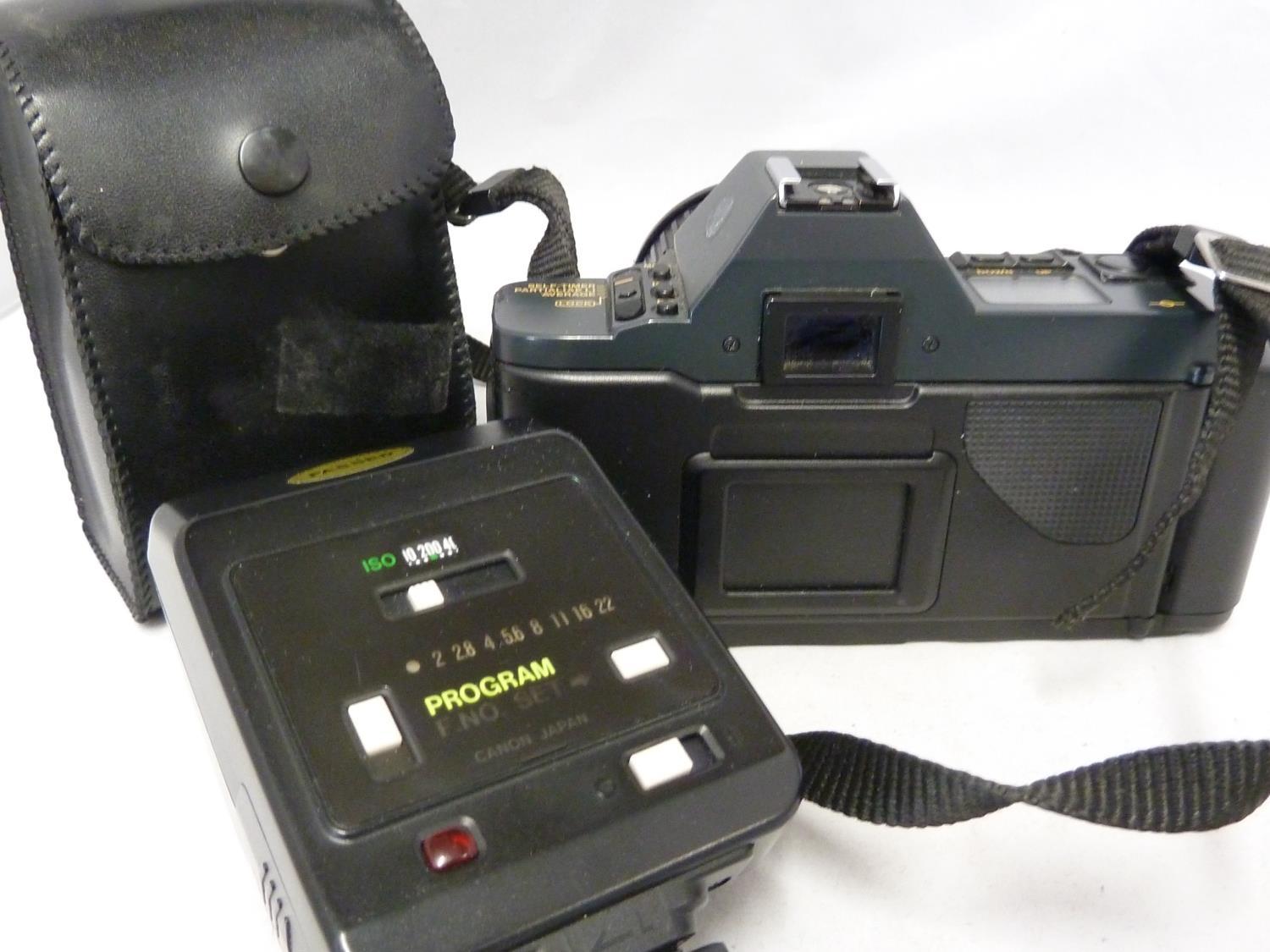 A Canon t70 camera body; a cannon Zoom Lens FD 35-70mm 1:3.6-4.5 with papers; and a Canon Speedlite - Image 5 of 5