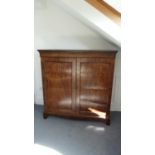 A mahogany boxwood strung cupboard, the two doors decorated with w 123cm x h 127cm x d 51cm