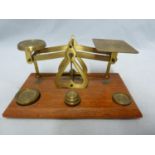 A set of vintage postage scales marked Warranted accurate and made in England on wooden plinth