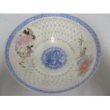 A Chinese eggshell porcelain bowl, the body decorated with translucent circular motifs in the manner