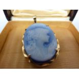 A cameo glass pendant, oval cut with a portrait of a young girl in profile, within a 18ct yellow