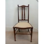 A Scottish Art Nouveau mahogany bedroom chair, the top rail inlaid with stylised flower buds, h 86.5