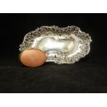 A Silver Rococo form pin tray, of irregular form composed of foliate 'c' scrolls and pierced