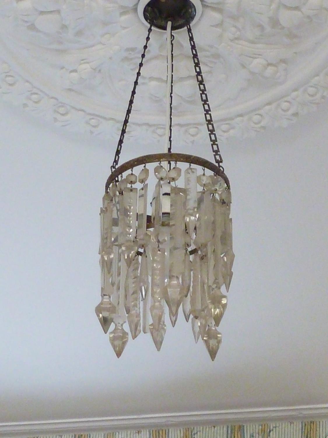 A pair of ceiling centerpiece lustre lights composed of various finger lustres on a central brass