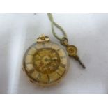 A ladies yellow metal fob watch marked 18K, the face decorated with flowers within roman numerals in