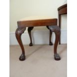 A George II style mahogany stool, the square upholstered seat on cabriole legs and ball and claw