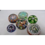 Paperweights - five millifiore decorated glass paperweights; and one enclosing a flower (6)