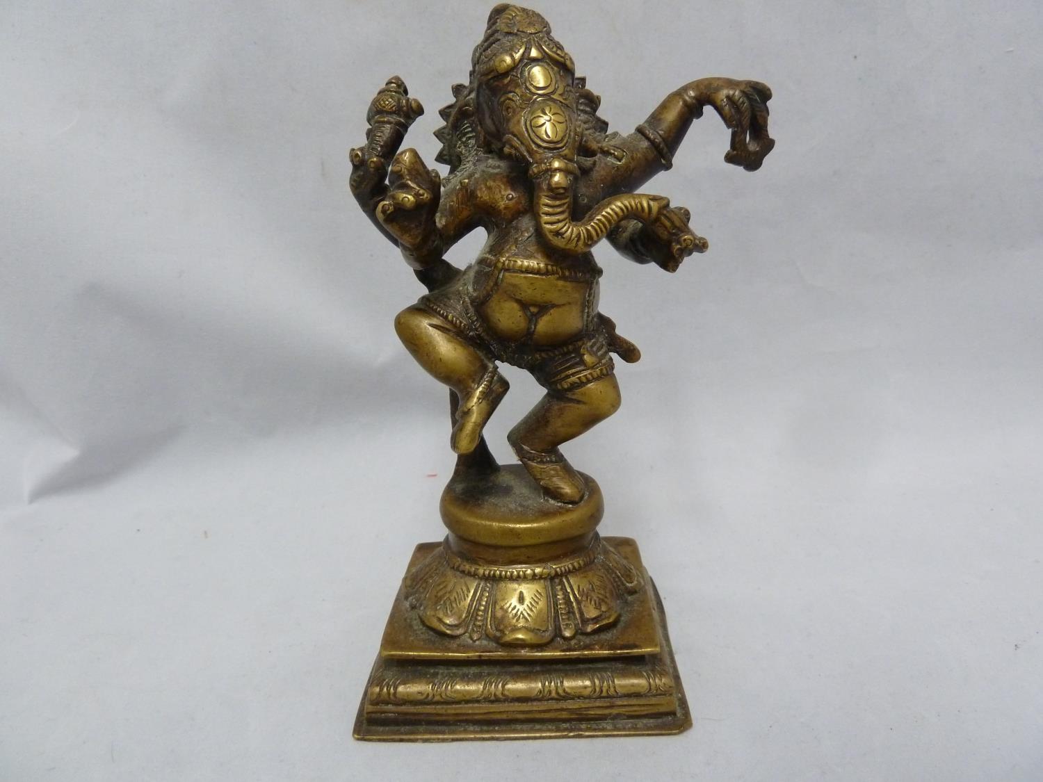 An Indian bronze figure of Ganesh as an elephant god, modelled standing on a lotus flower on stepped