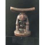 An African Tribal or Ethnographic Art carved wood figural headrest, possibly Luba Tribe the curved