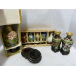 A collection of eight Chinese miniature cloisonne vases; and nine small size carved wood stands,