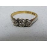 A three stone diamond illusion set ring, set in part platinum and part 18ct yellow gold, ring size N