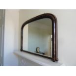 A Victorian gesso Gothic Revival arched top over mantel mirror, the ebonised finish gilded with