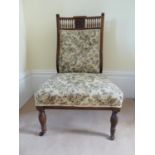 Victorian nursing chair, the back rail carved with flower and fern reserve, 84 cm high *** by family