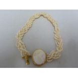 A freshwater pearl rope twist choker necklace - set with shell cameo clasp set in yellow metal and