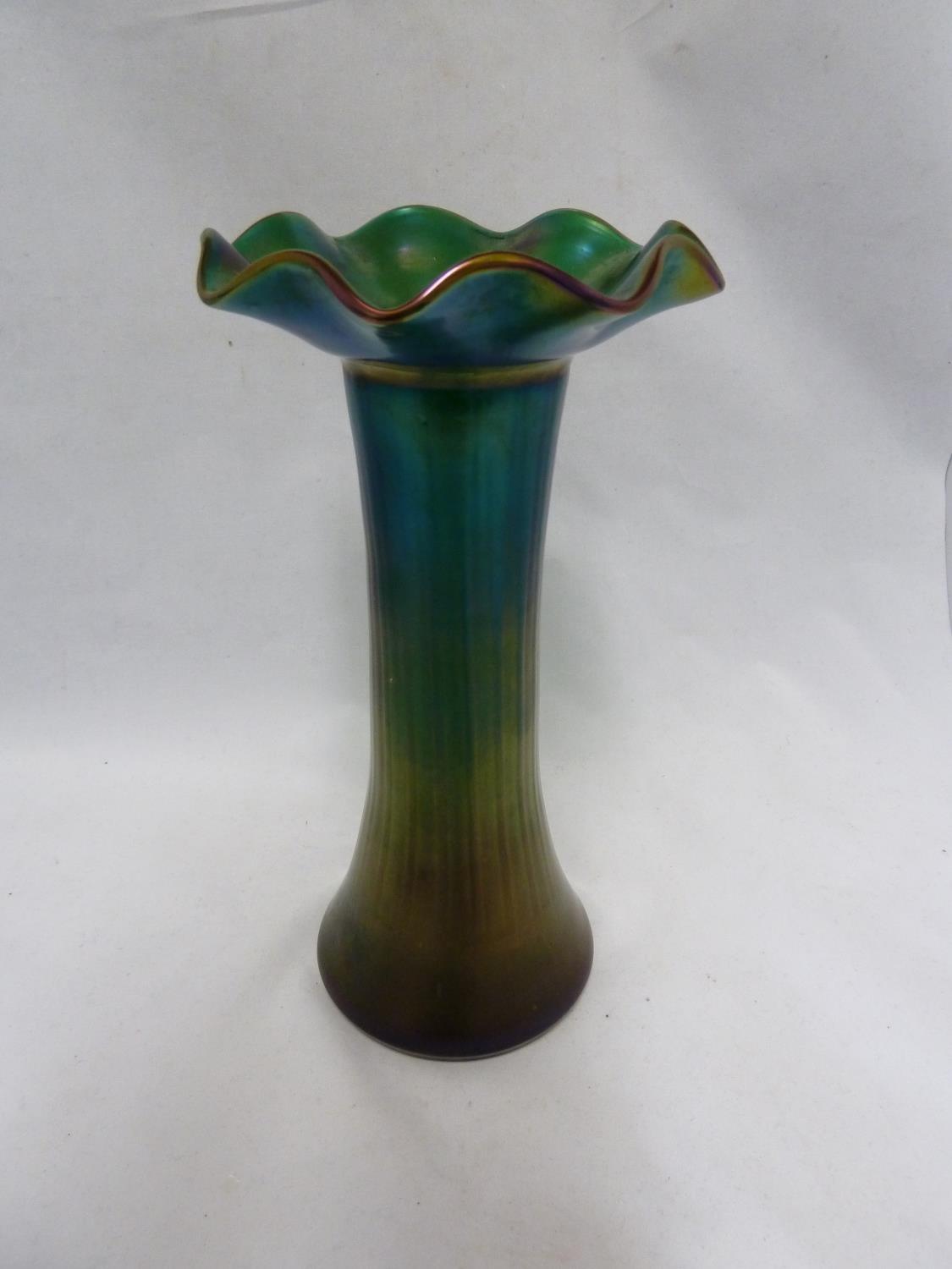Kralik - An iridescent green glass vase, in Loetz style, of flared cylindrical form with wavy rim,