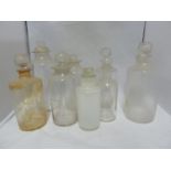 Nine various Chemists/Pharmacy bottles, cylindrical with cut and blown stoppers, 23 cm high and