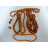 Various items of amber set jewellery comprising: two graduated round bead necklaces with screw