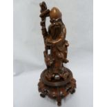 A Chinese bamboo root carving of an immortal holding a staff and peach with a stork to one side,