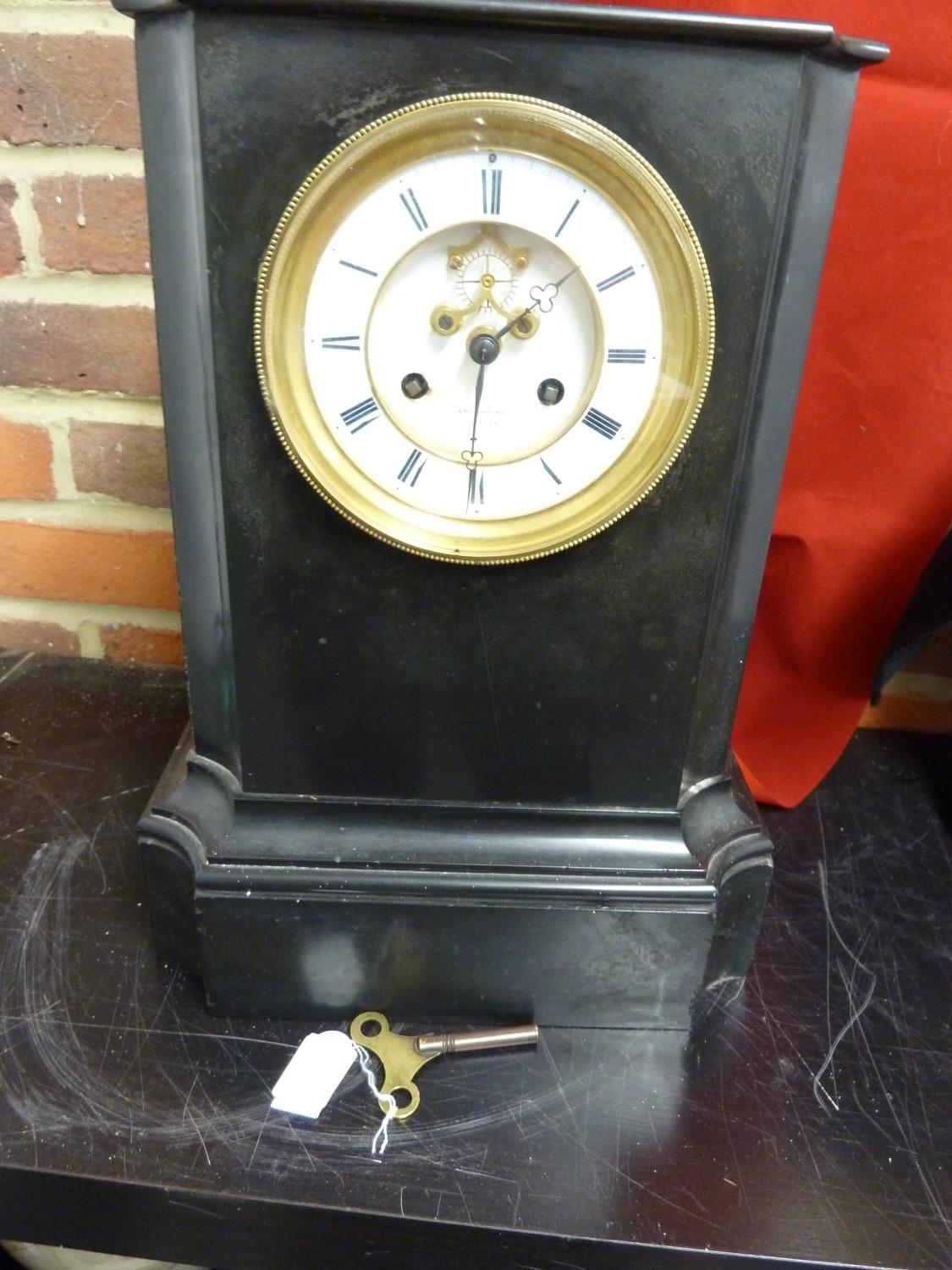 A black slate clock the dial marked Ambrosoni a Paris, with key (2)