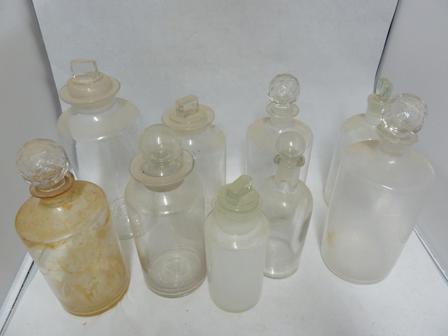 Nine various Chemists/Pharmacy bottles, cylindrical with cut and blown stoppers, 23 cm high and - Image 2 of 3