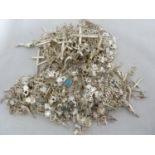 A large quantity of white metal charms, crucifixes and bracelets (qty)