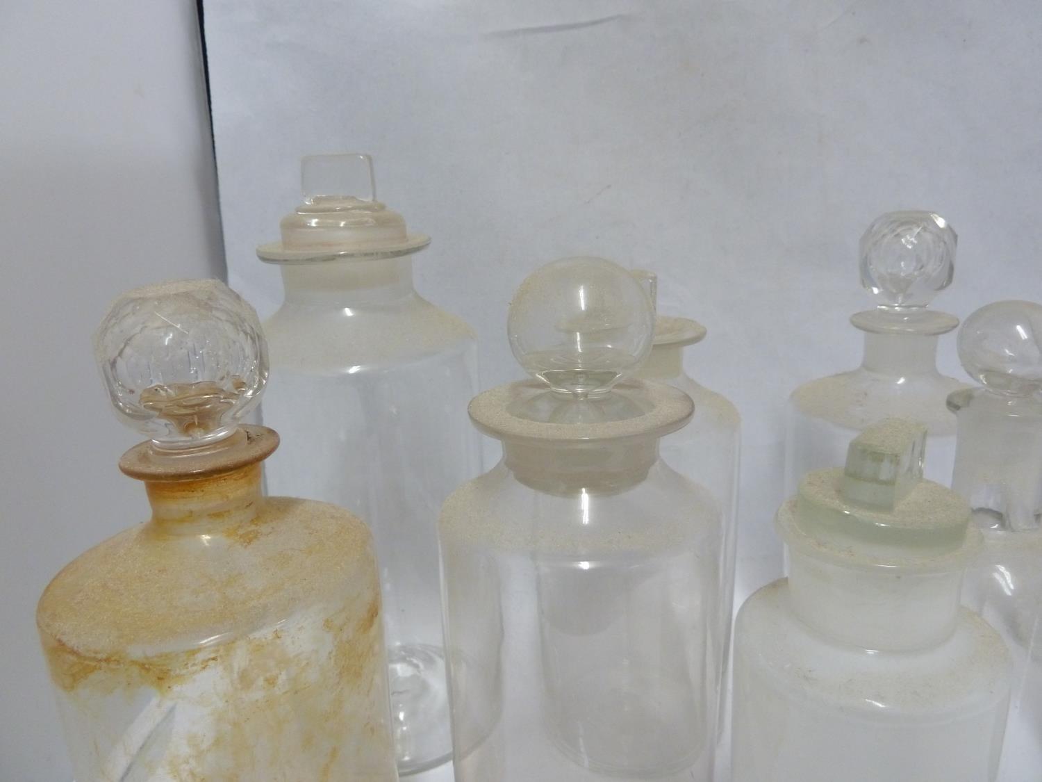 Nine various Chemists/Pharmacy bottles, cylindrical with cut and blown stoppers, 23 cm high and - Image 3 of 3