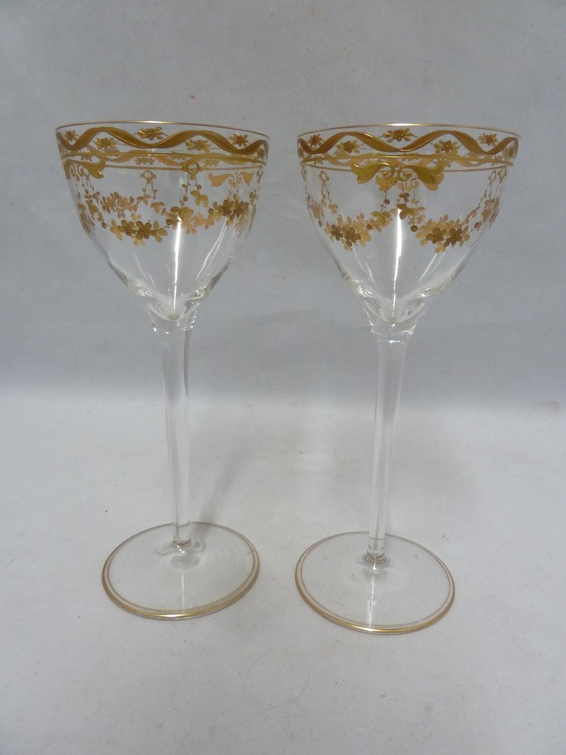 A pair of Continental glass wine glasses, probably Josephinehutt, the bowls decorated in two