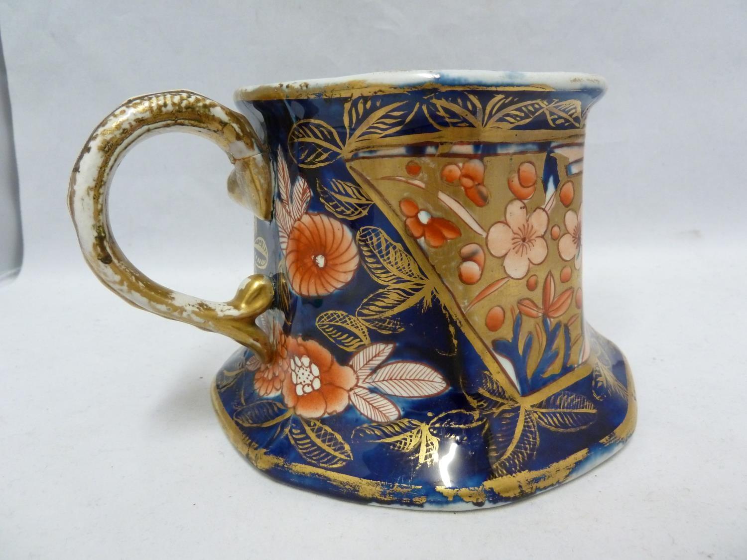 An Early Mason's Patent Ironstone cider mug, decorated in the School House pattern in the Imari