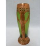 An Austrian Secessionist green iridescent glass vase with copper overlay cut as a column with laurel