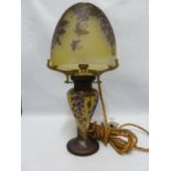 A cameo glass table lamp and cover, the domed glass shade on glass baluster stem cased in amethyst
