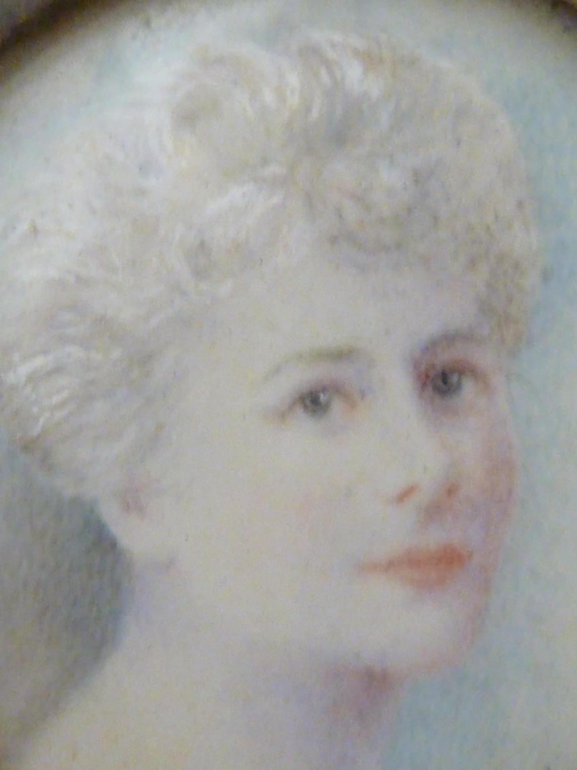A portrait miniature of a woman, within a circular white metal frame set with half 'pearls', paper - Image 3 of 5