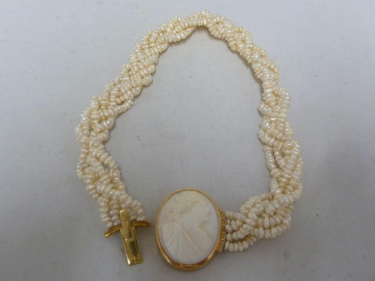 A freshwater pearl rope twist choker necklace - set with shell cameo clasp set in yellow metal and