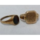 Two yellow gold signet rings, one marked 9ct and set with an oval black stone, ring size L 1/2,