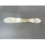 A Regency mother of pearl letter knife, the handle formed as a neo-classical vase with acanthus leaf