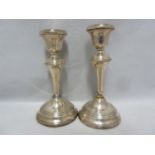 A pair of silver candlesticks, with reeded rims, Birmingham 1955, makers mark B&Co for Broadway &
