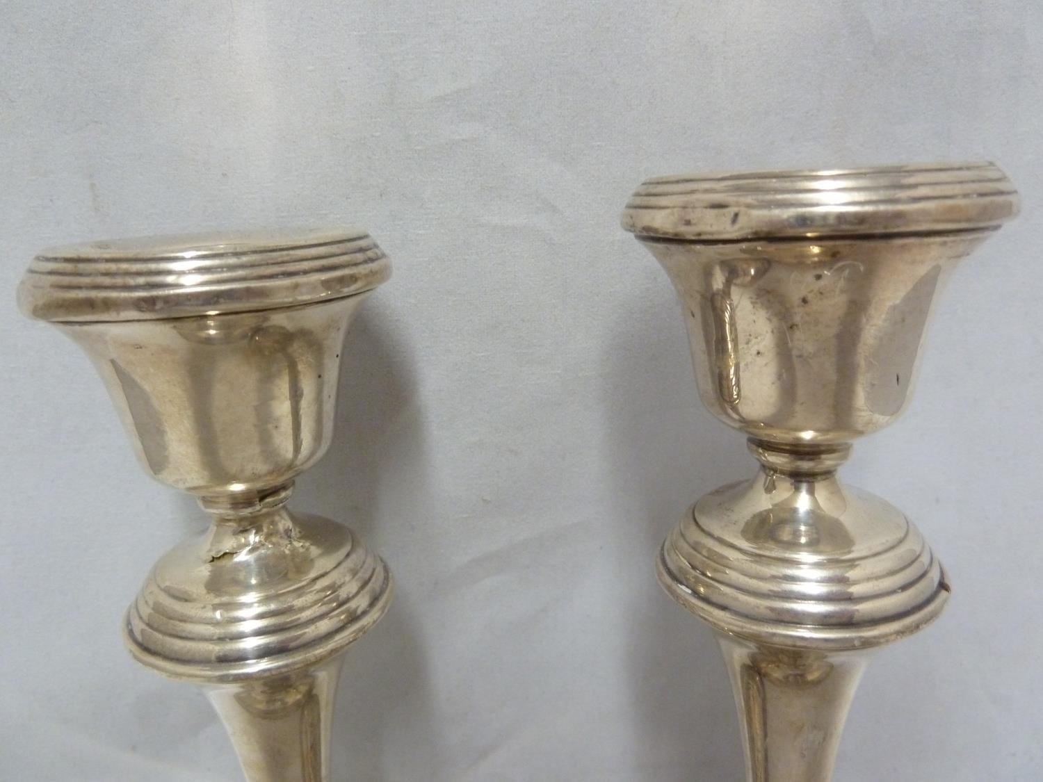 A pair of silver candlesticks, with reeded rims, Birmingham 1955, makers mark B&Co for Broadway & - Image 2 of 9