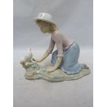 Nao - a porcelain figure of a girl kneeling with a dove on a tree stump, 16.5cm high approx