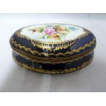 A 'Sevres' porcelain box and cover, shaped oval, decorated with reserves of Summer flowers on a