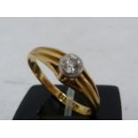 A solitaire diamond ring, the round brilliant cut stone of 0.15 carat approx set in an 18ct yellow