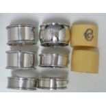 Six silver napkin rings, various dates and makers; and two celuloid napkin rings set with silver