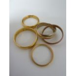 Four gold wedding rings comprising: a 22ct yellow gold band, 5.5grms approx, ring size L; a 22ct