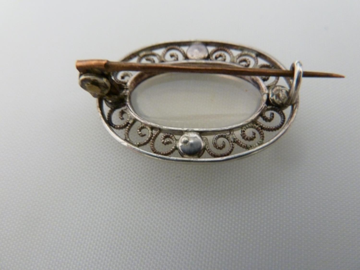 A Belle Epoque pendant and brooch set, the white metal filigree work supporting oval moonstones - Image 6 of 7